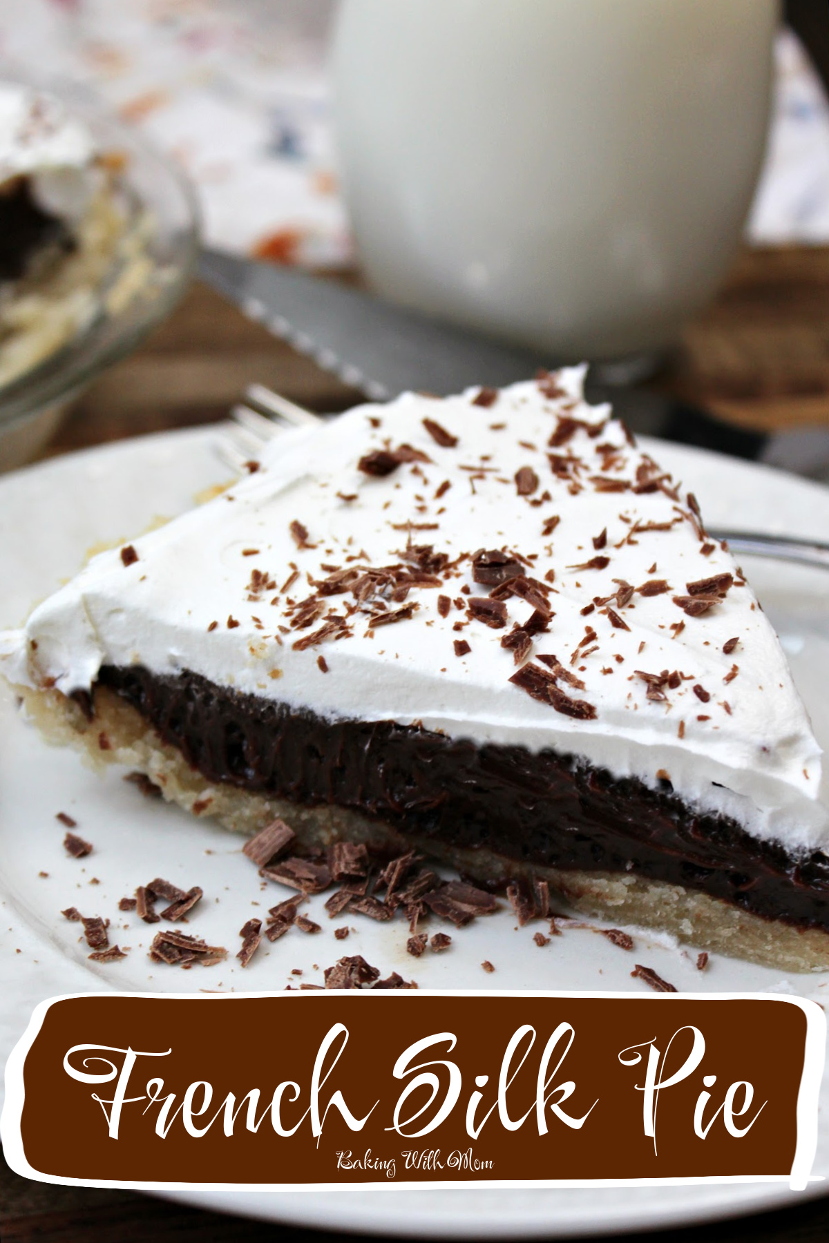 French silk pie on a white plate with chocolate shavings scattered around. 