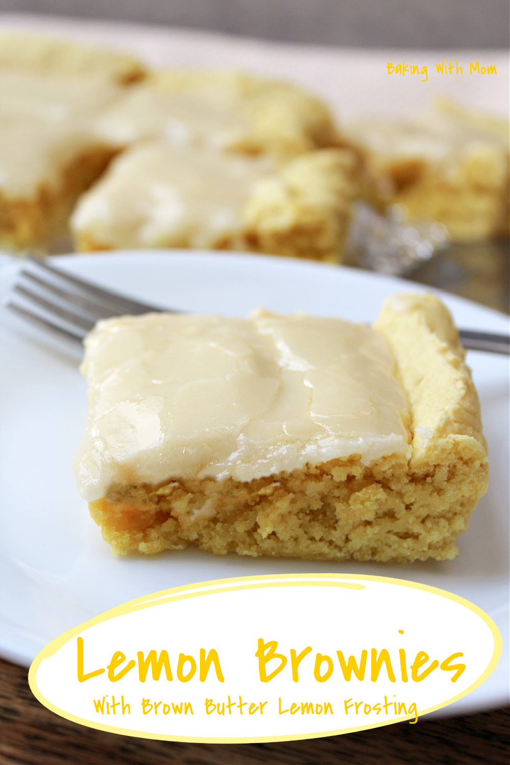 lemon brownies on a white plate with a fork. 