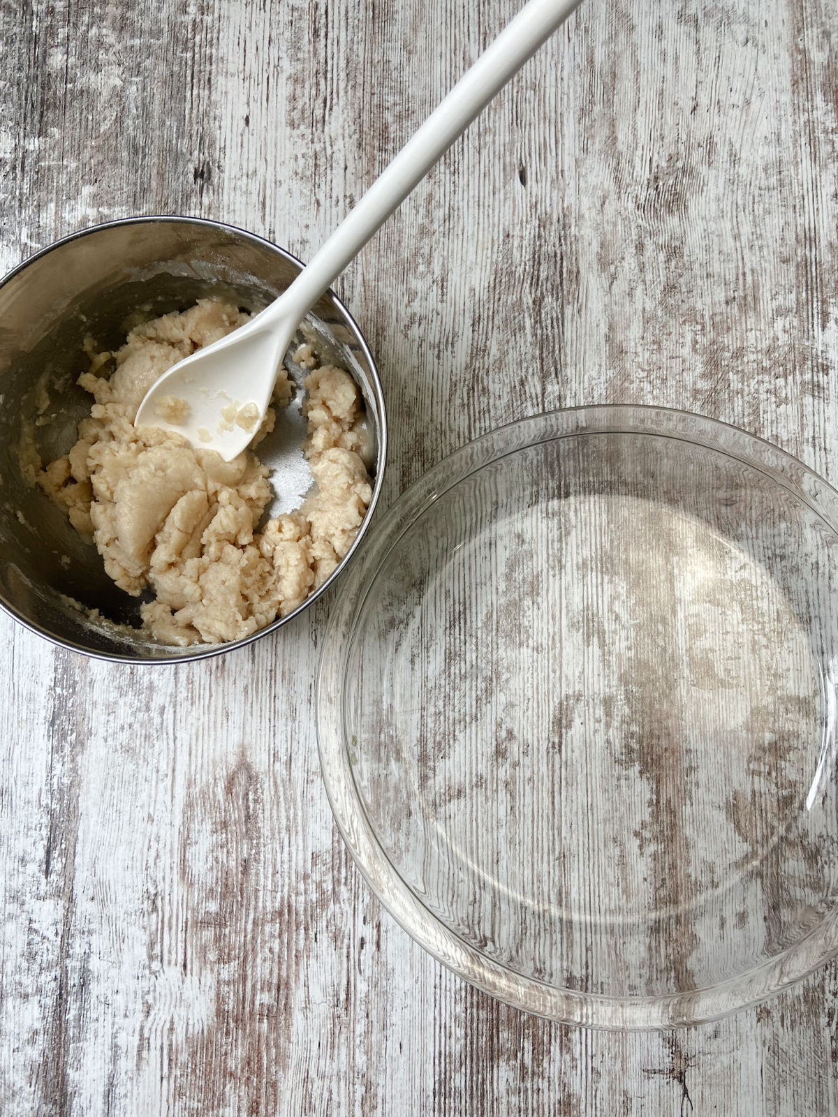 pie crust in a silver bowl by a pie pan.