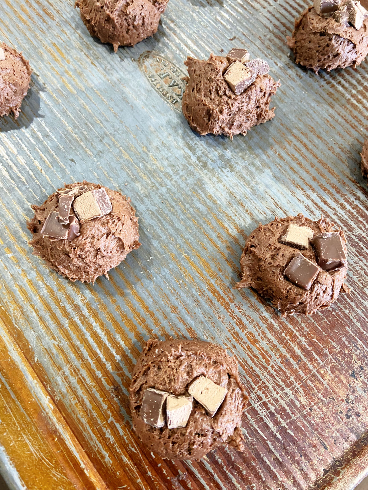 unbaked cookies on a baking sheet. 