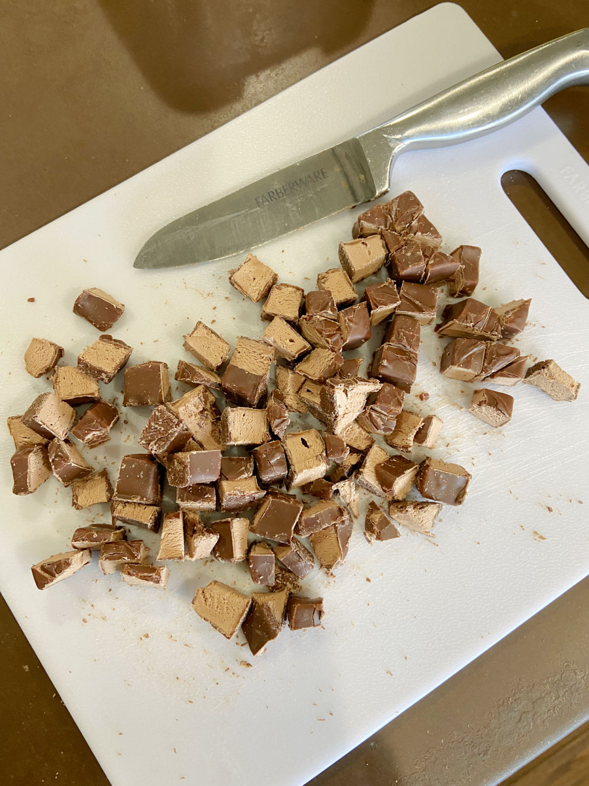 3 Musketeers chopped on a cutting board. 