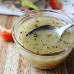 Homemade Italian Dressing in a clear bowl with a spoon.