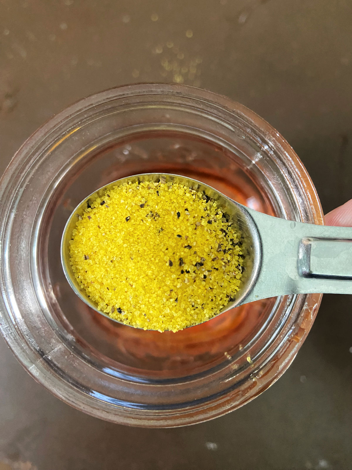 lemon pepper in a measuring spoon. 