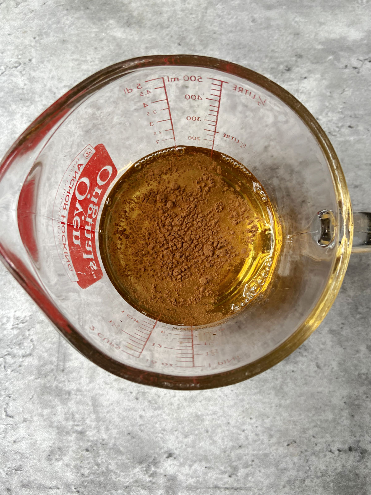 apple juice with cinnamon in a measuring cup. 