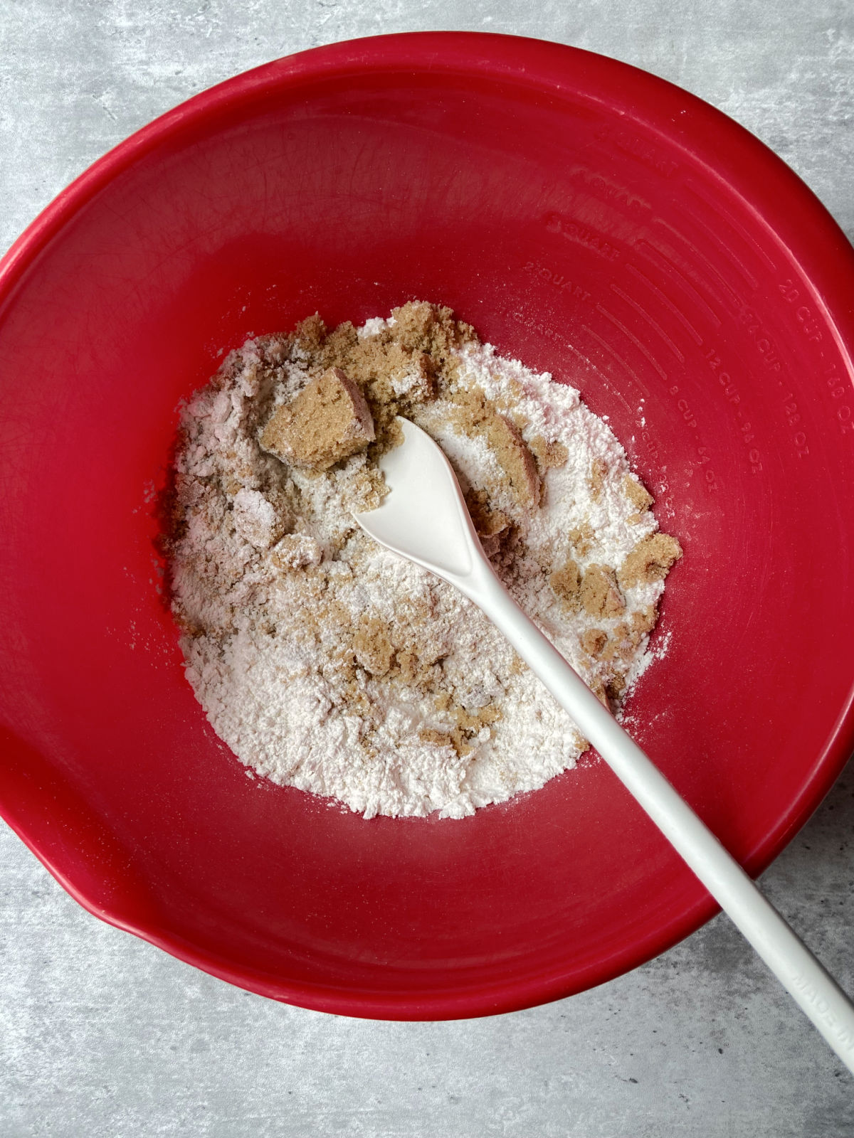 flour and brown sugar in a red bowl. 