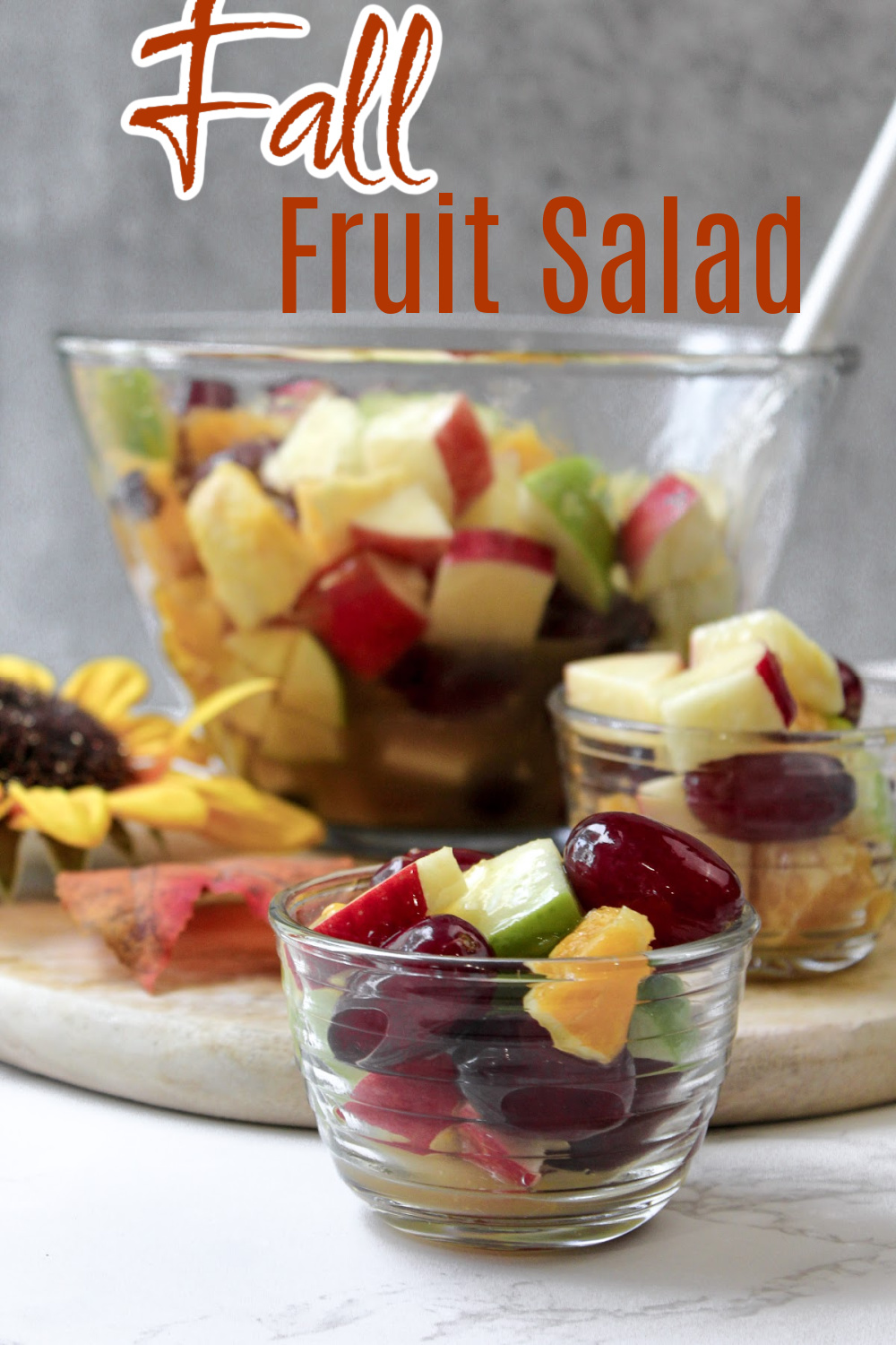 fall fruit salad in a clear bowl with a spoon. 