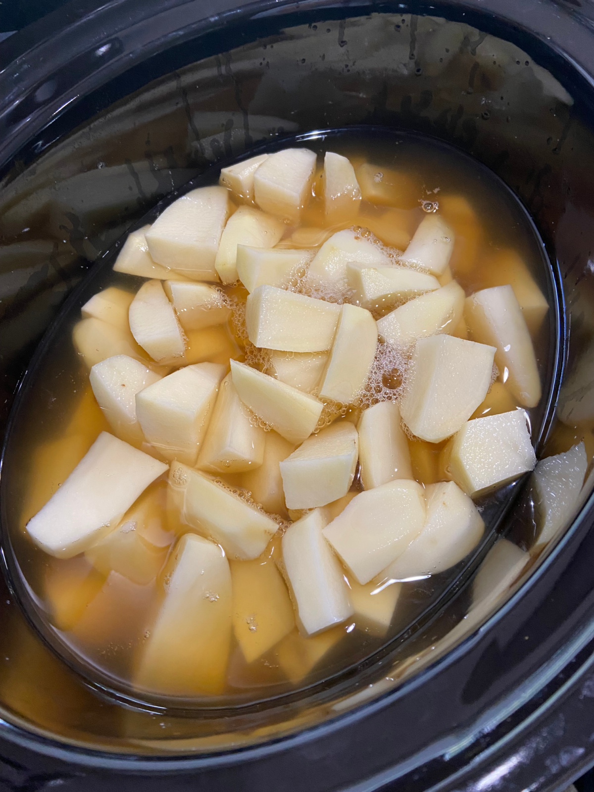 potatoes in a crock pot with chicken broth. 
