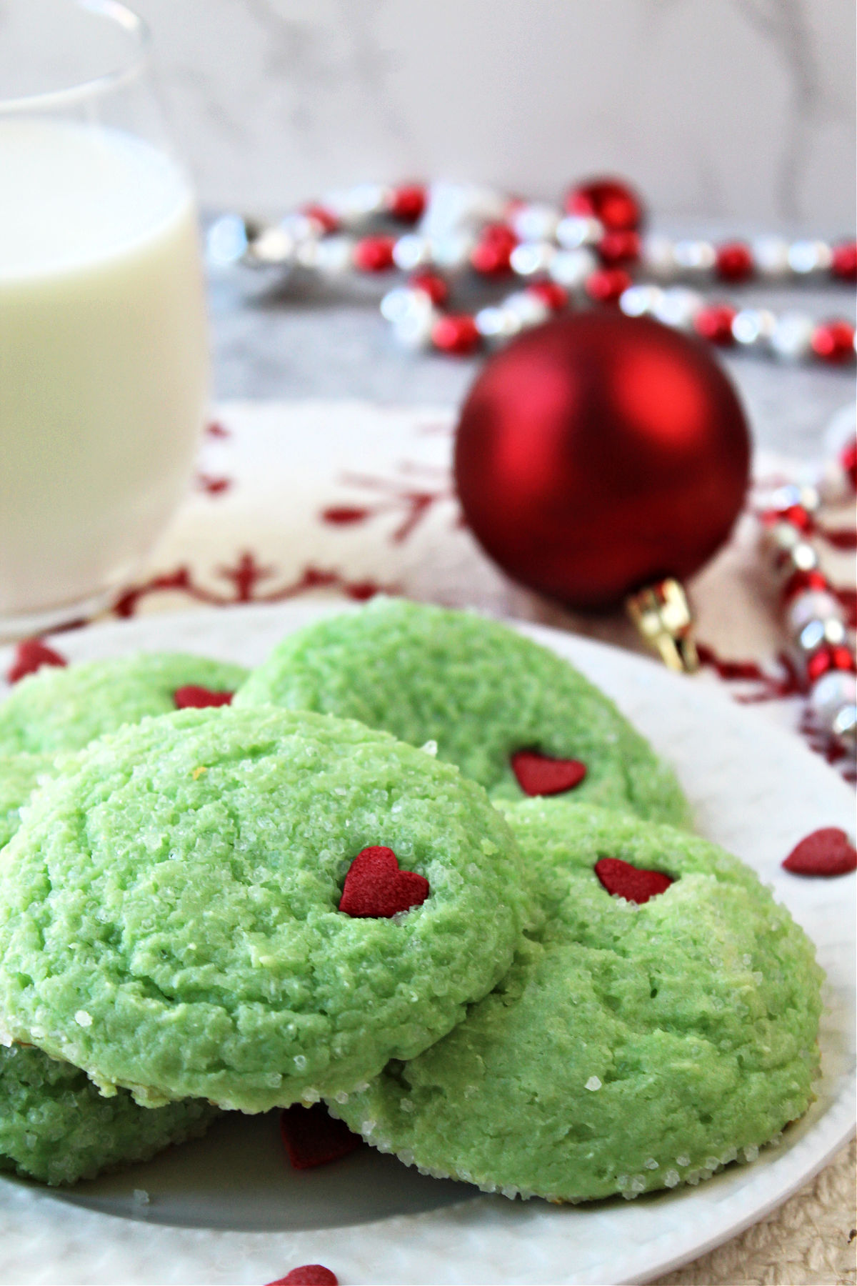 Grinch cookies on a white plate. 