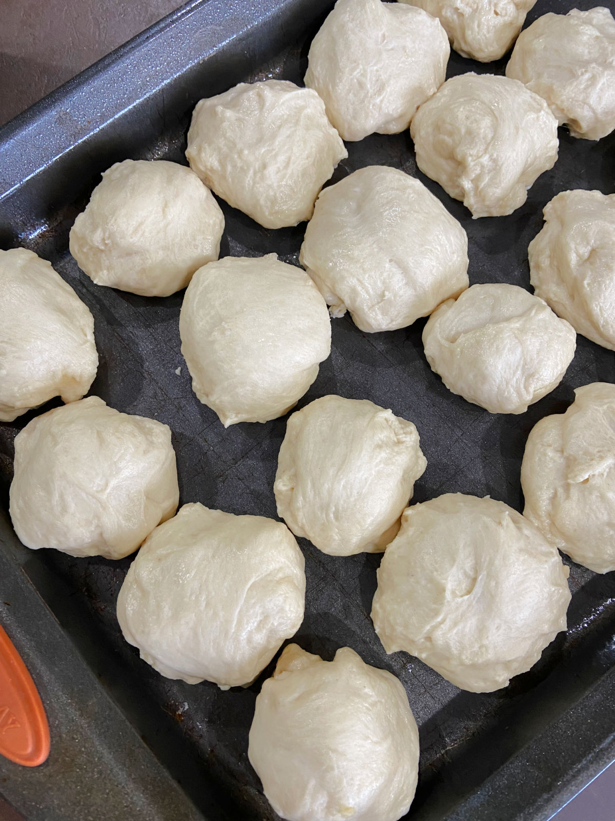 Uncooked rolls on a baking sheet.