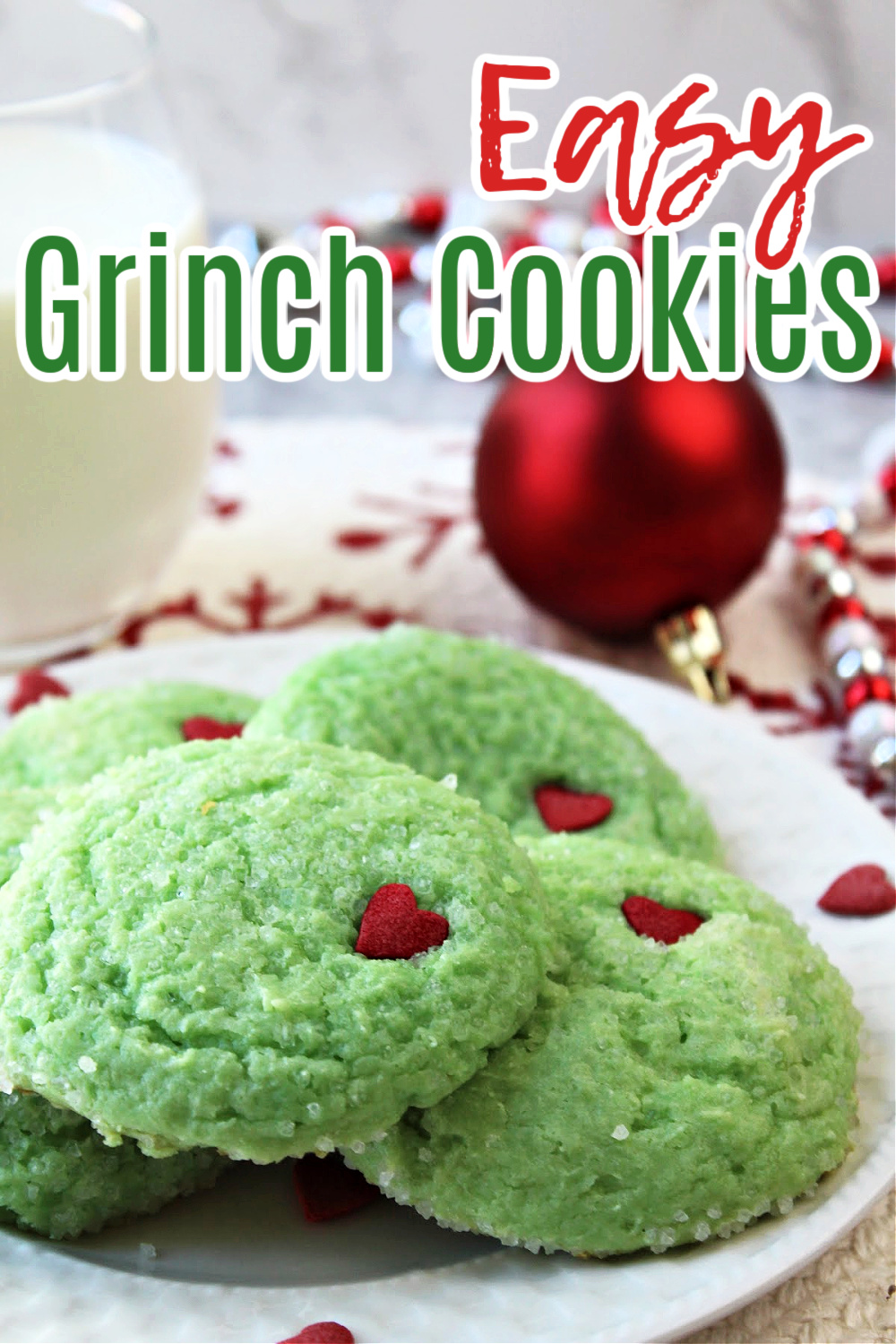 grinch cookies on a white plate with milk. 