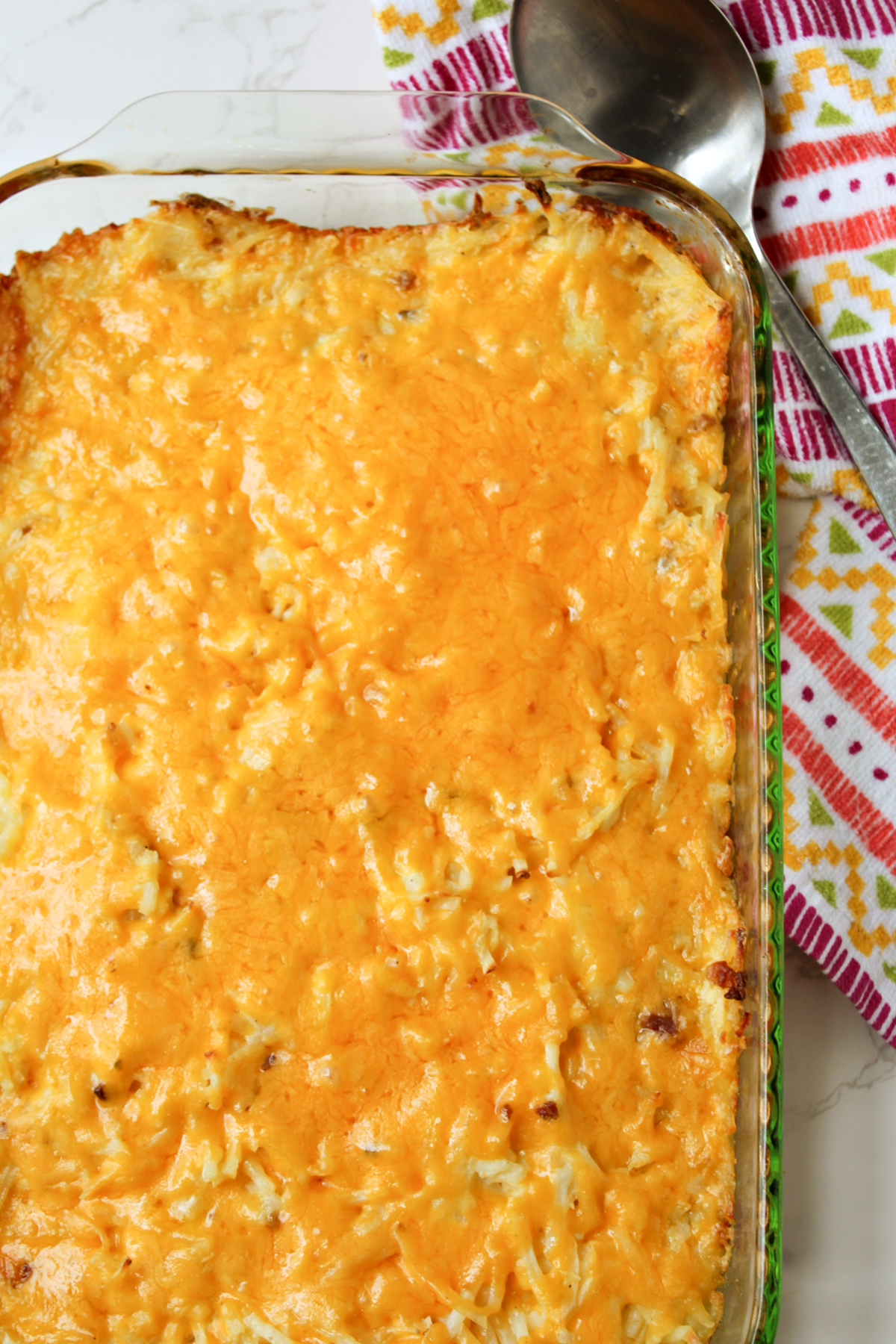 Funeral Potatoes in a clear baking dish. 