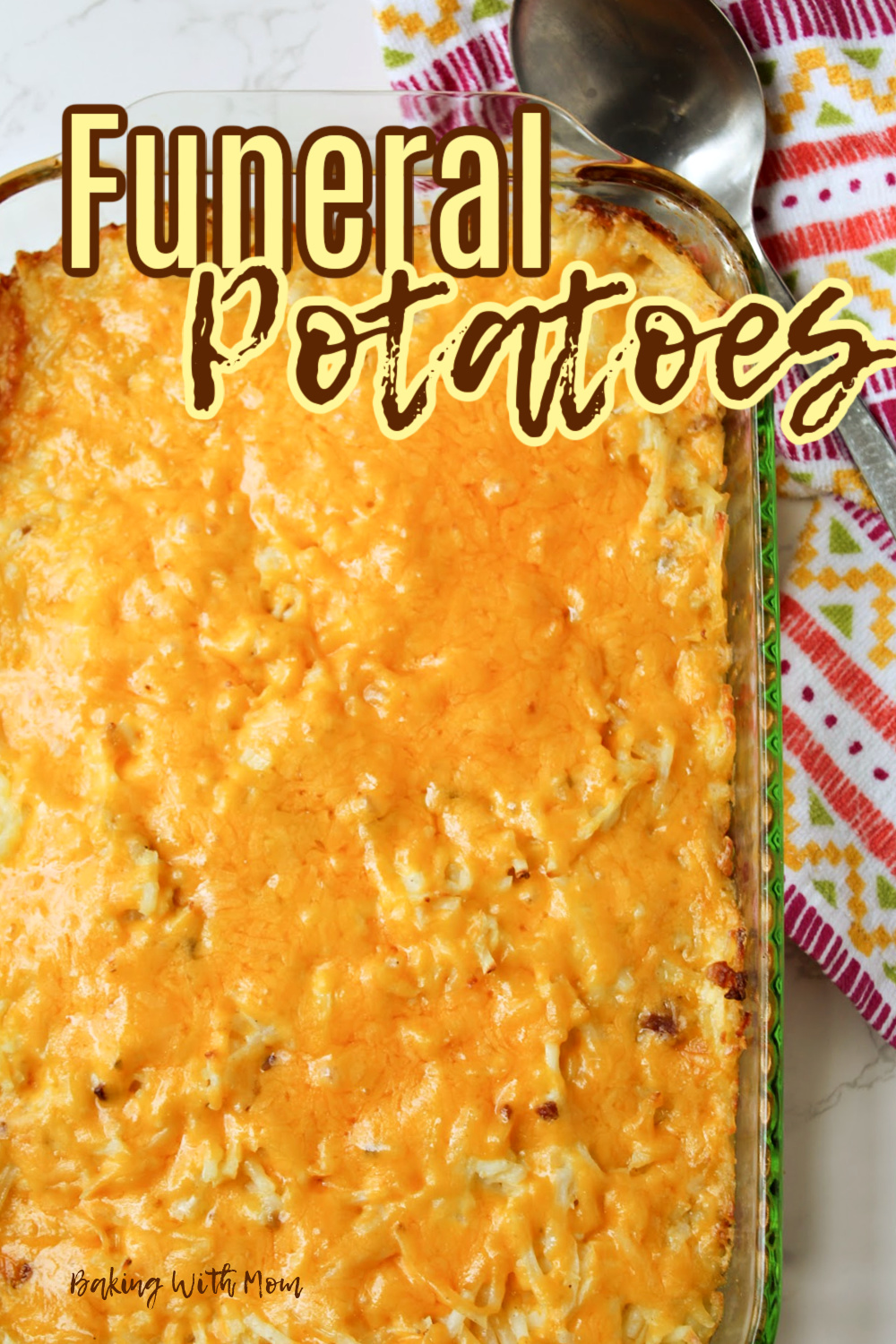 funeral potatoes in a clear baking dish with a towel. 