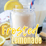 Frosted lemonade in a clear glass with a straw.