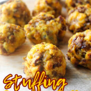 stuffing sausage balls on a tray.