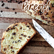 Chocolate chip bread on a brown cutting board.
