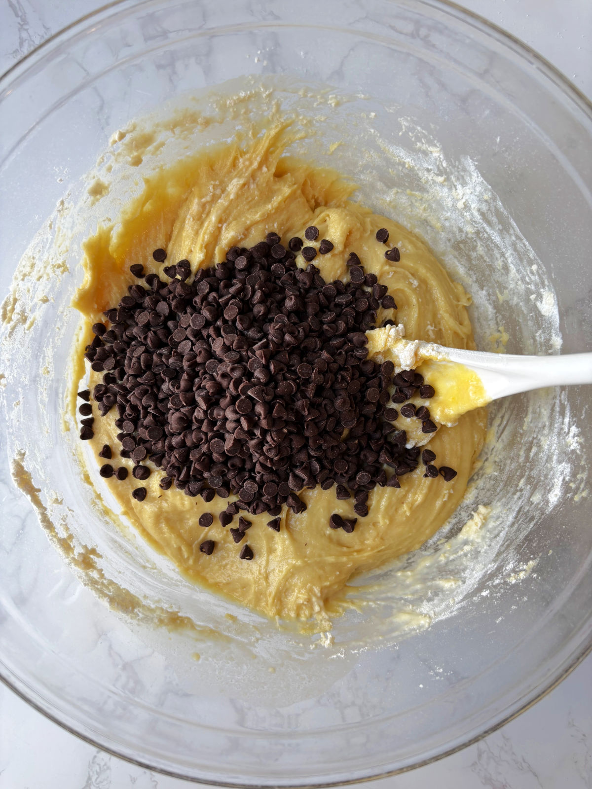 chocolate chips in a bowl of bread batter. 