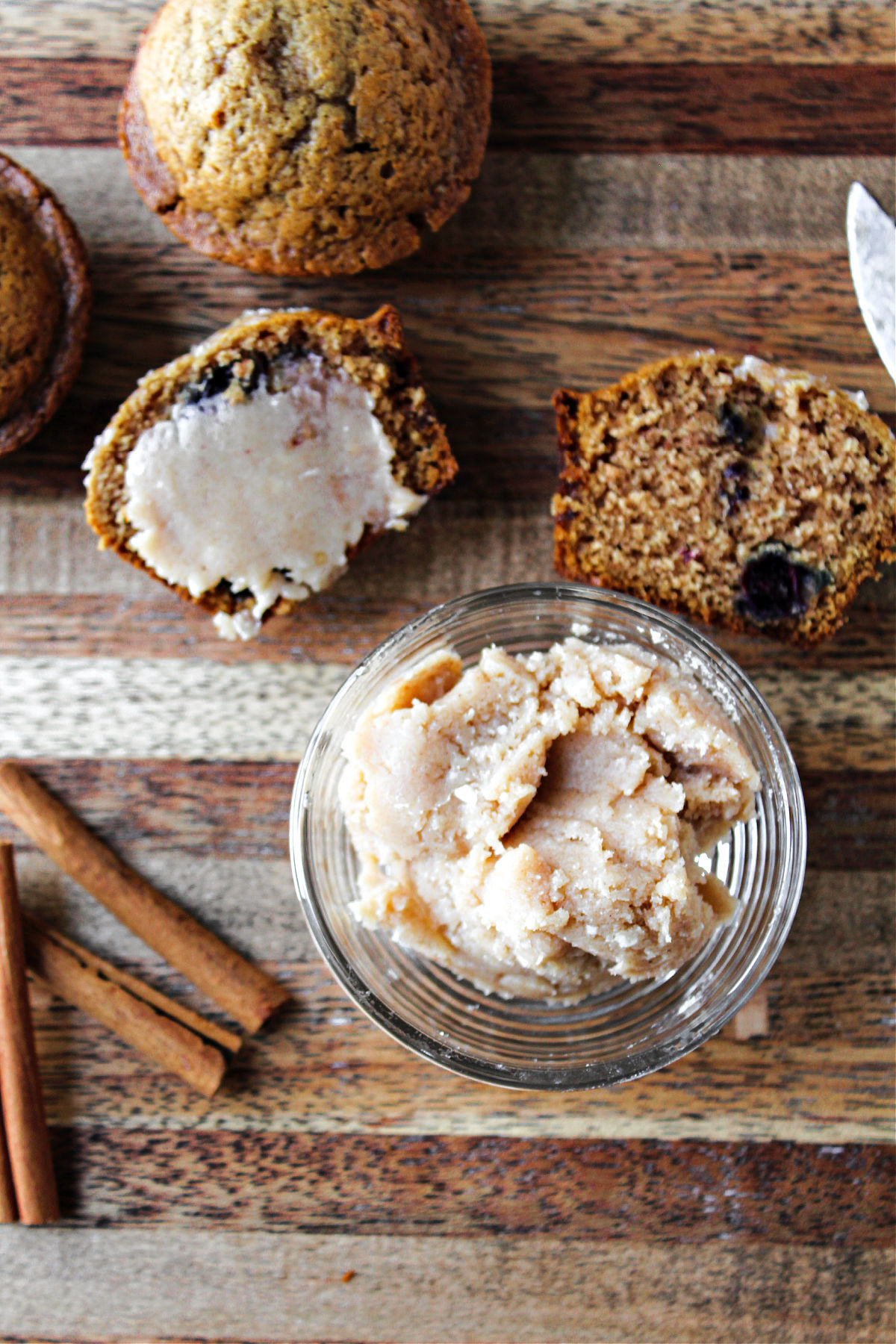 Cinnamon Honey Butter in a bowl with muffins nearby. 