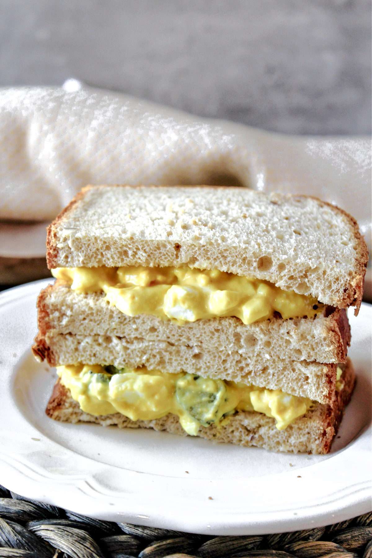 Egg salad on a plate with bread.