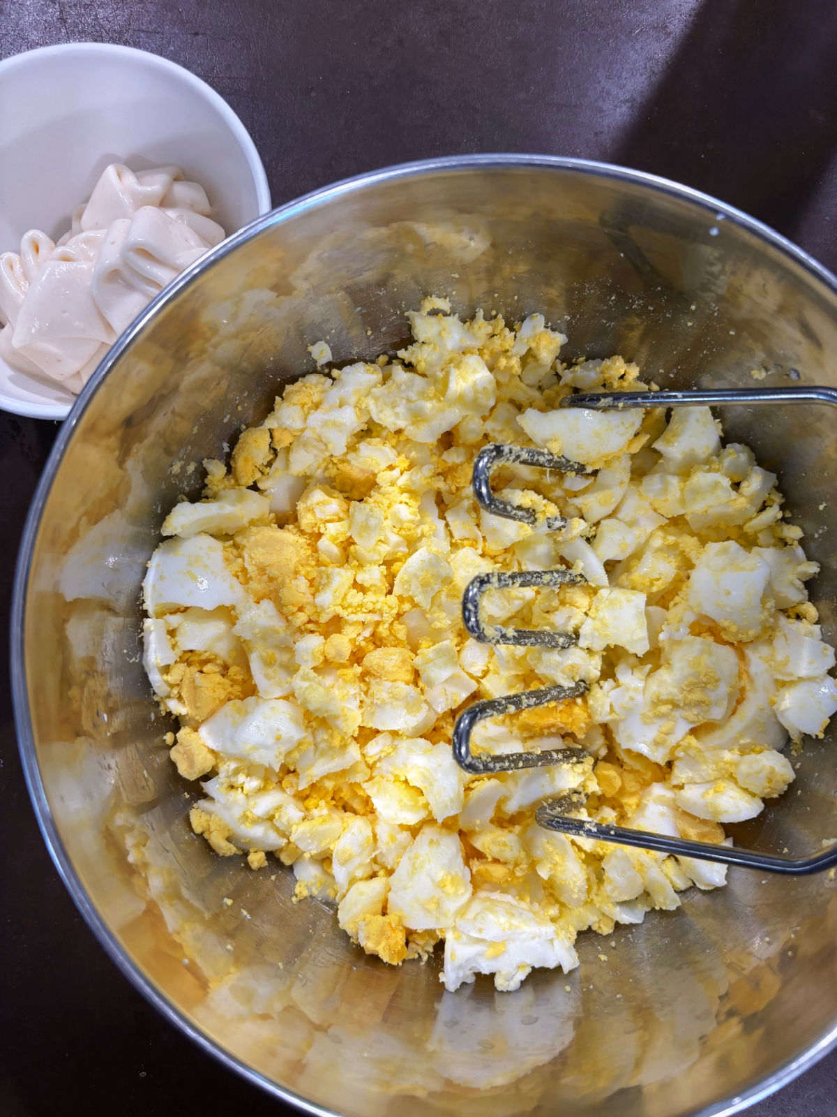 eggs in a bowl with miracle whip behind. 