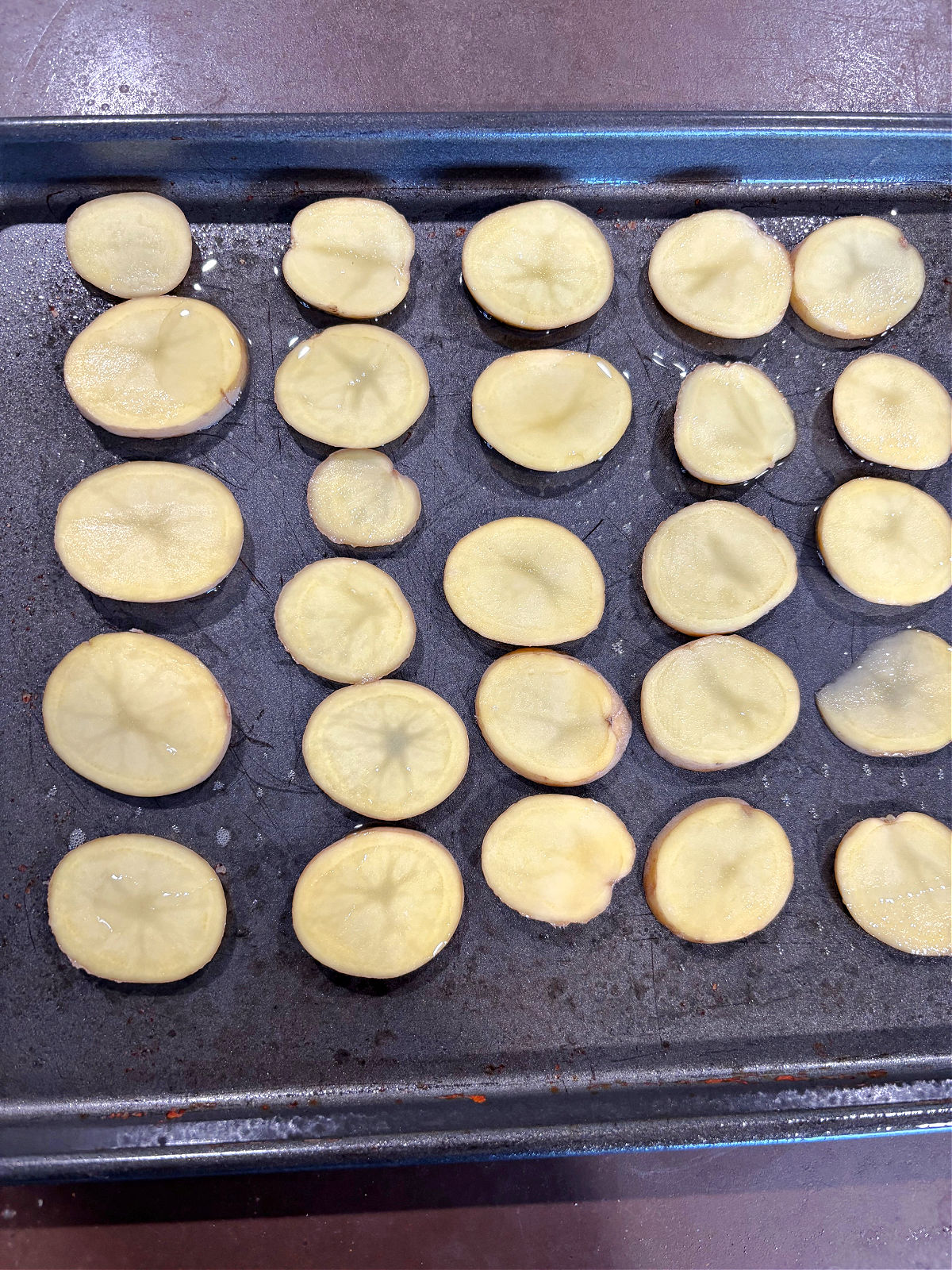 sliced potatoes on a tray. 