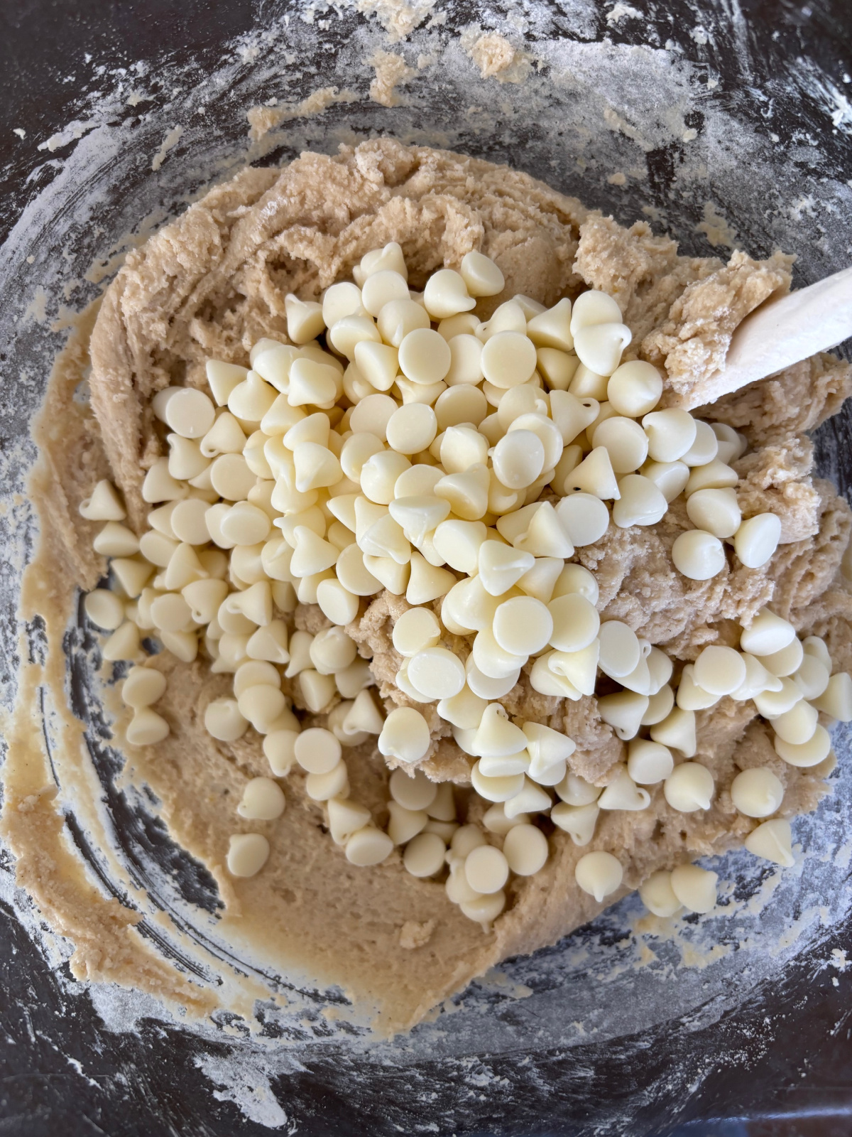 white chocolate chips in a large bowl with cookie dough. 