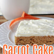 carrot cake bars with cream cheese frosting with a glass of milk behind.