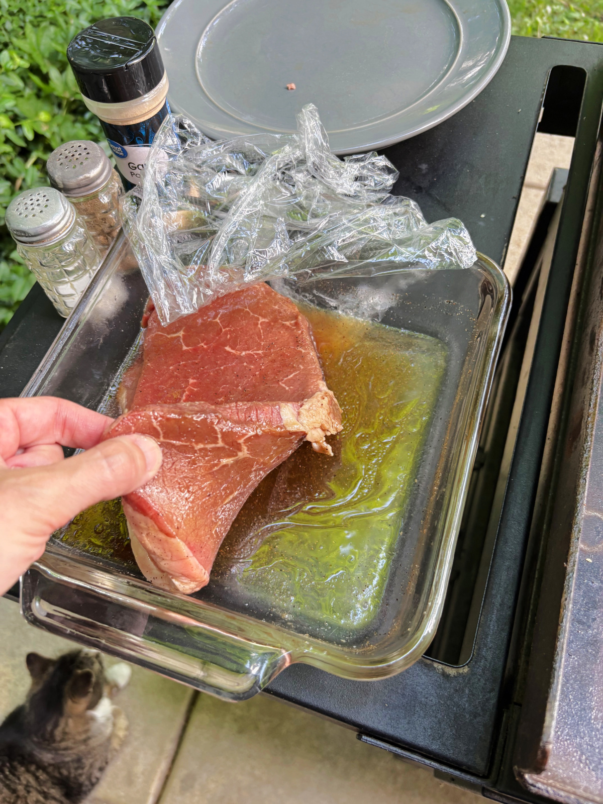 steak marinade in pan with a plate nearby.