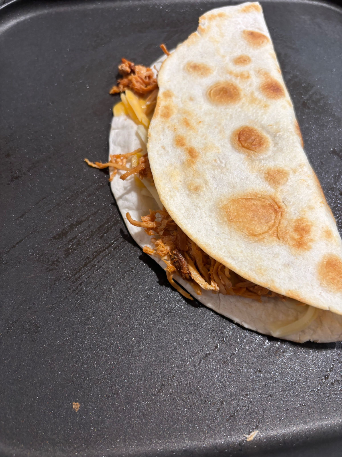 folded tortilla over chicken.