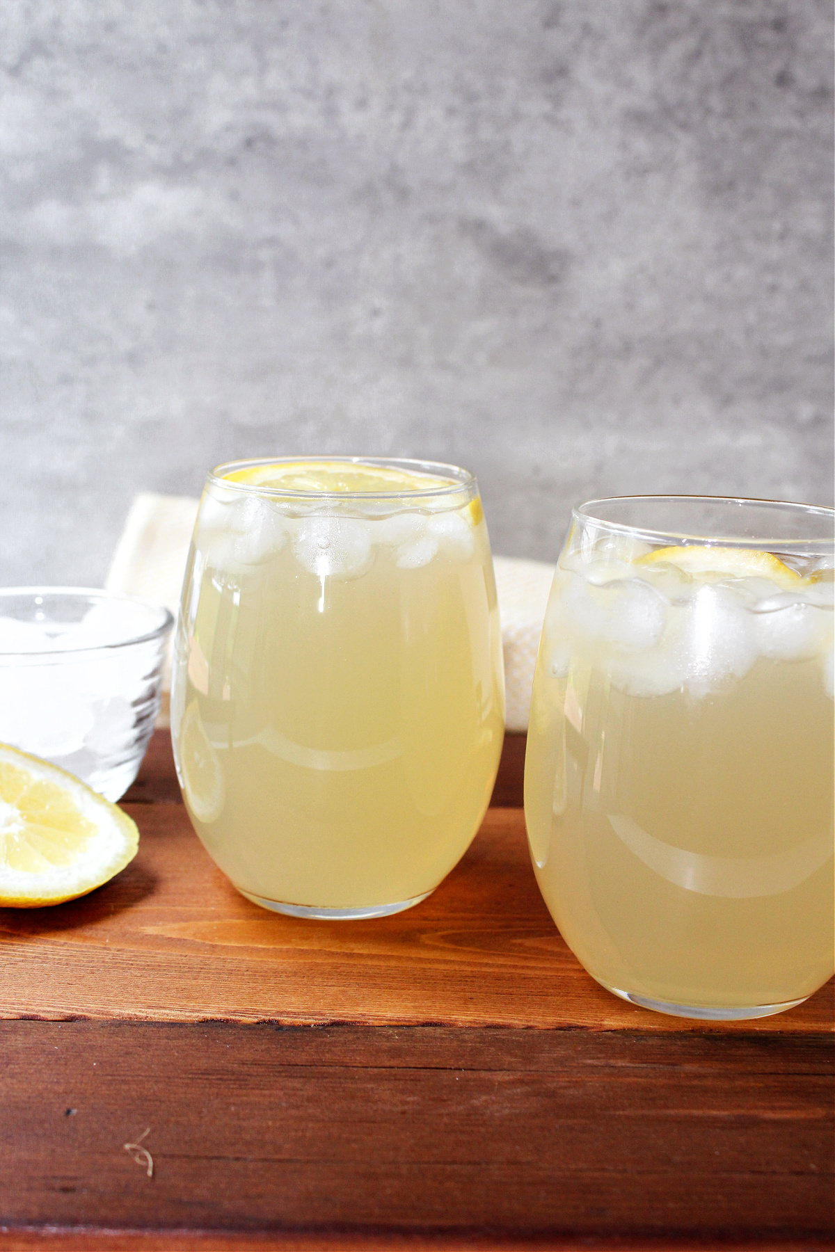 sparkling lemonade in a clear glass with lemons.