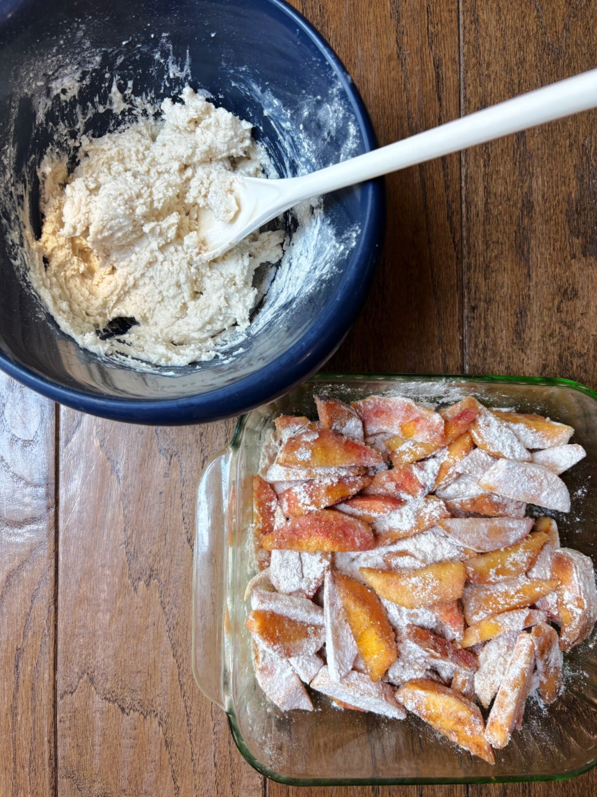 peached in a pan with a bowl of topping.