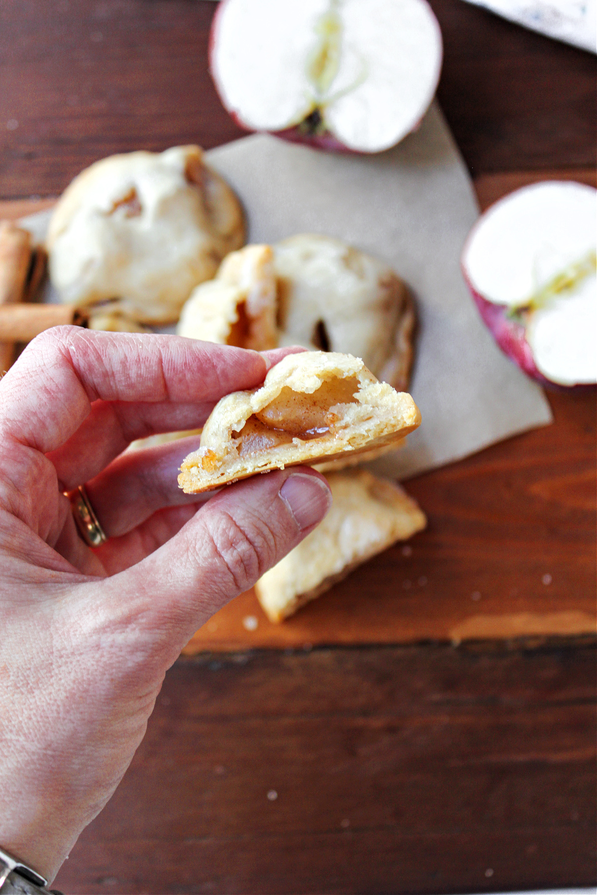 hand holding an apple pie bite.