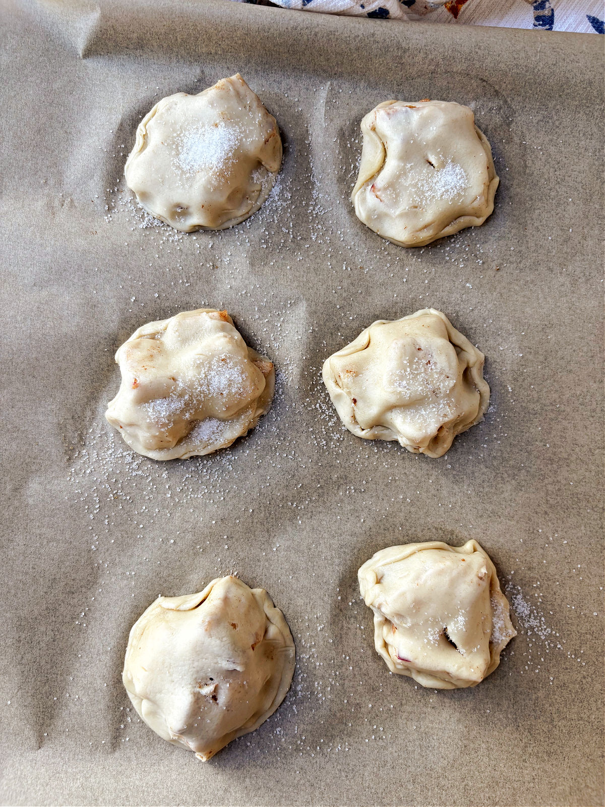 apple pie bites on a baking sheet.