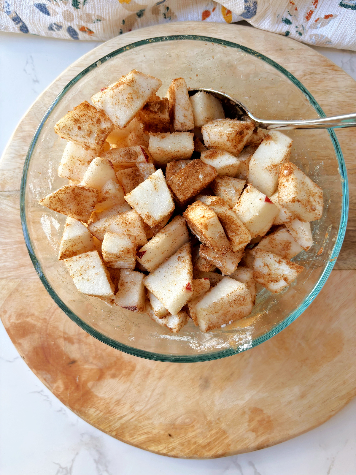 cinnamon sugar apples in a clear bowl.