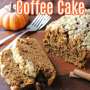 Pumpkin Coffee Cake on a brown board with forks behind.