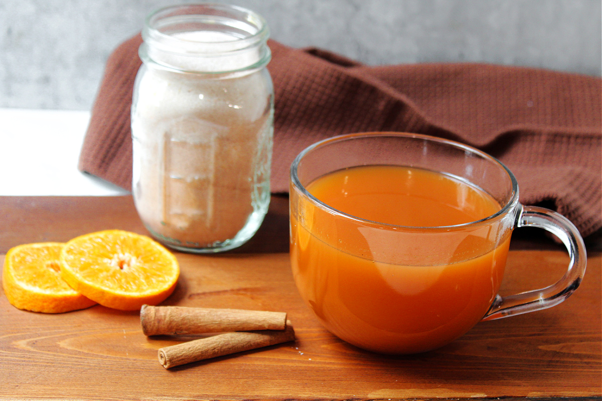 Russian tea with cinnamon sticks and orange slices.
