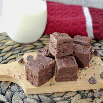 fudge on a wooden board with a towel behind.