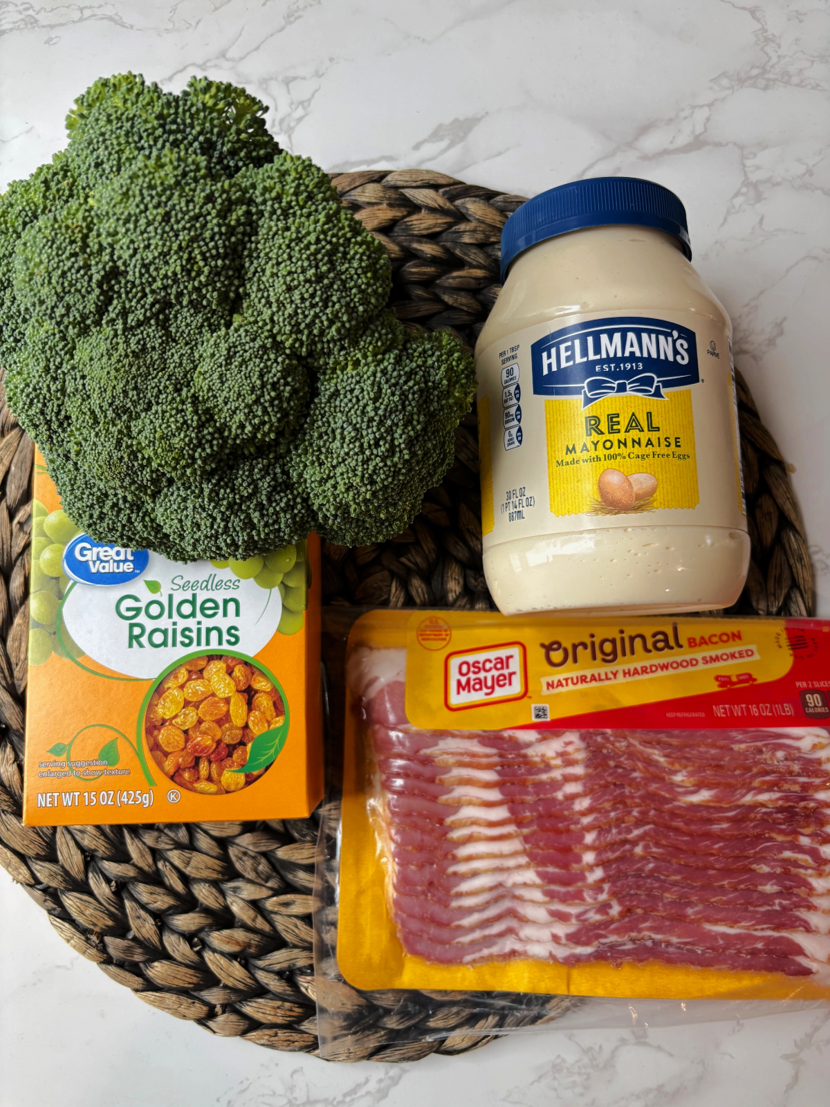 broccoli, bacon, raisins, mayo on a brown mat.