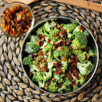 broccoli salad with raisins in a glass bowl.