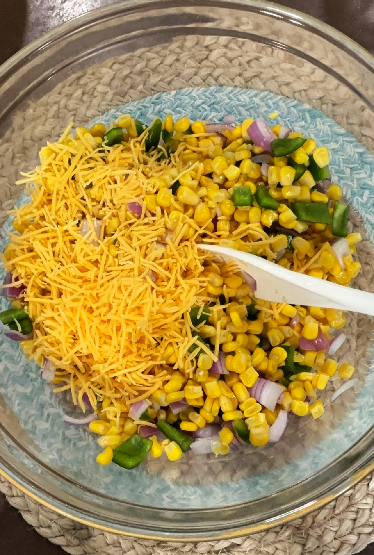 cheese with corn in a clear bowl.