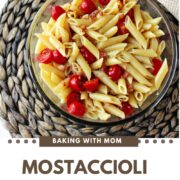 Mostaccioli Salad in a clear bowl on a brown mat.