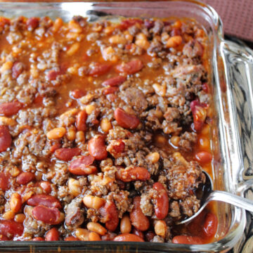 Venison baked beans in a glass baking dish.