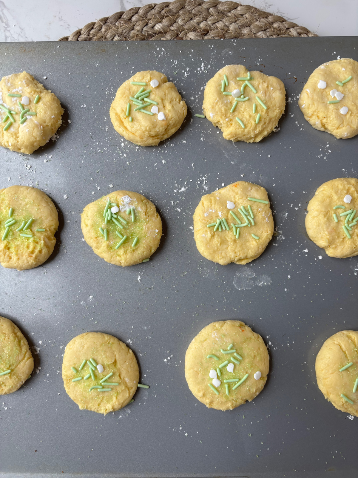 cookies on a cookie sheet with sprinkles.