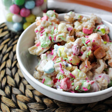 Easter marshmallow candy in a white bowl on a brown mat.