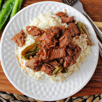Swiss Steak on rice with a fork nearby.
