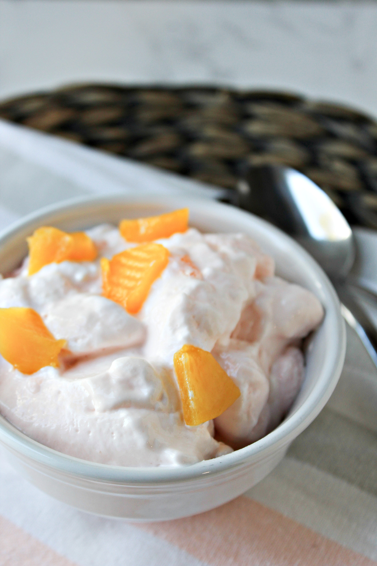 peach lemonade fluff in a bowl with a spoon.