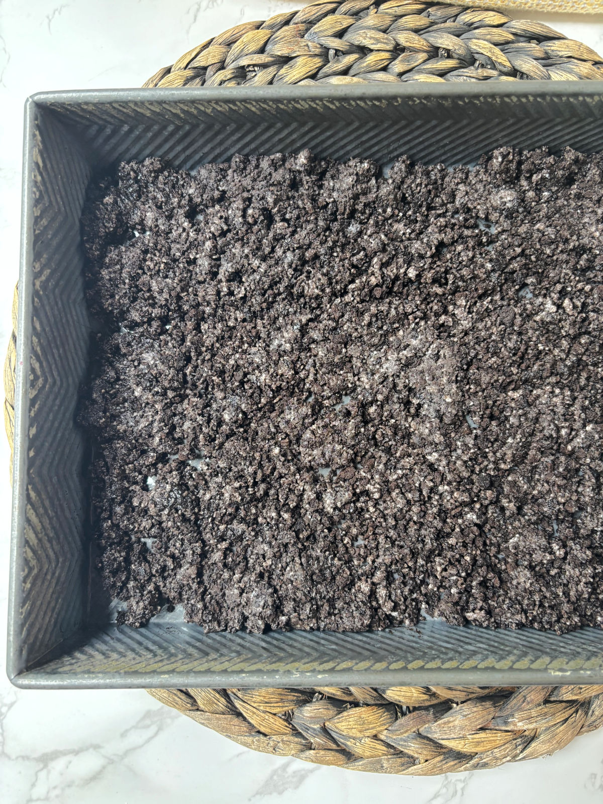 Oreo crumbs in a pan.