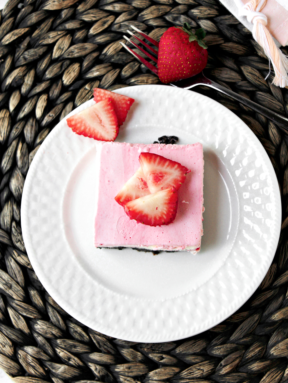 strawberry ice cream cake slice with strawberries.