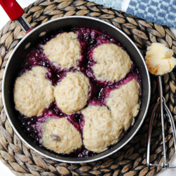 blueberry dumplings with a scoop of ice cream nearby.