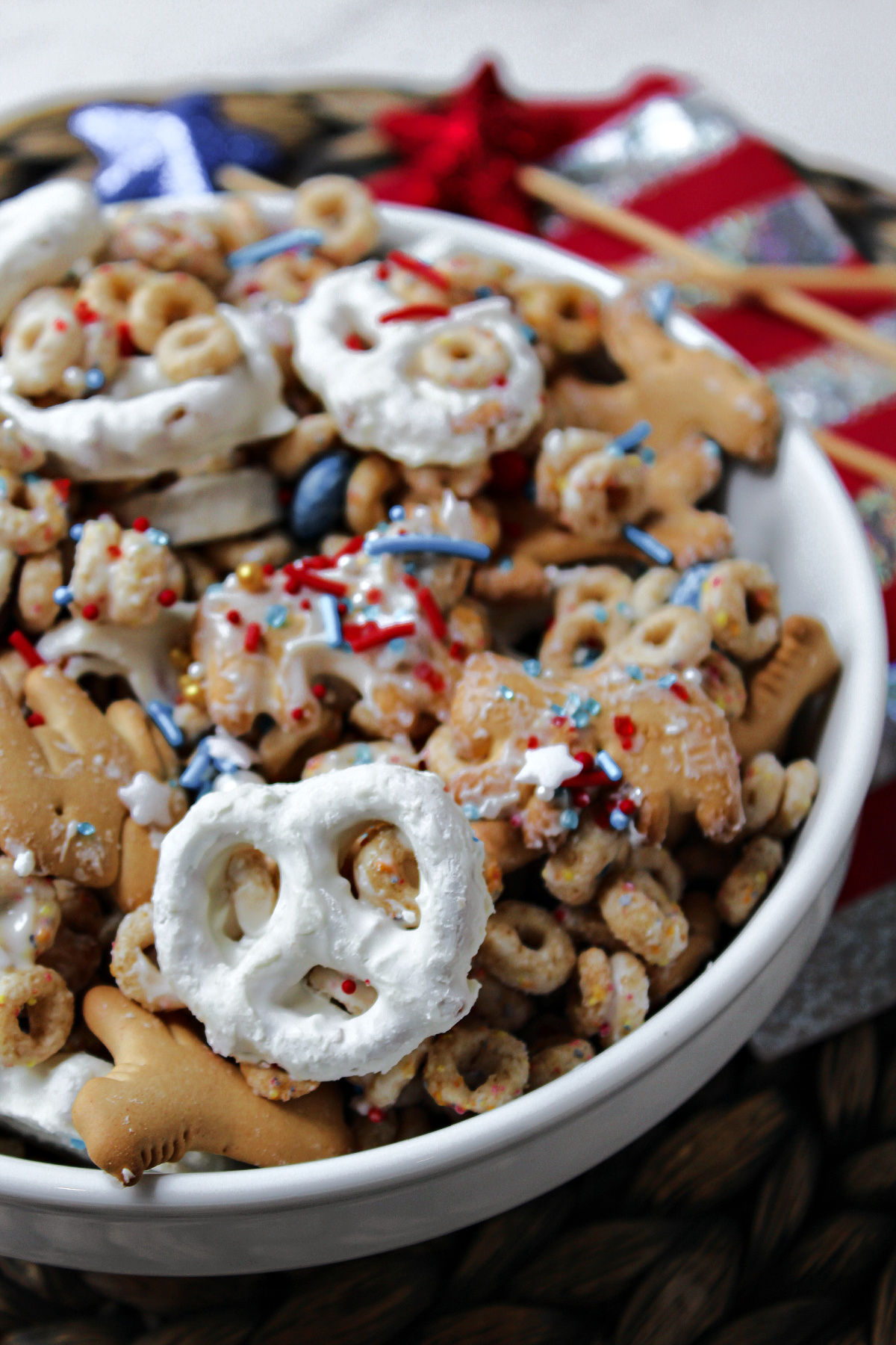 close up of party mix in a white bowl.