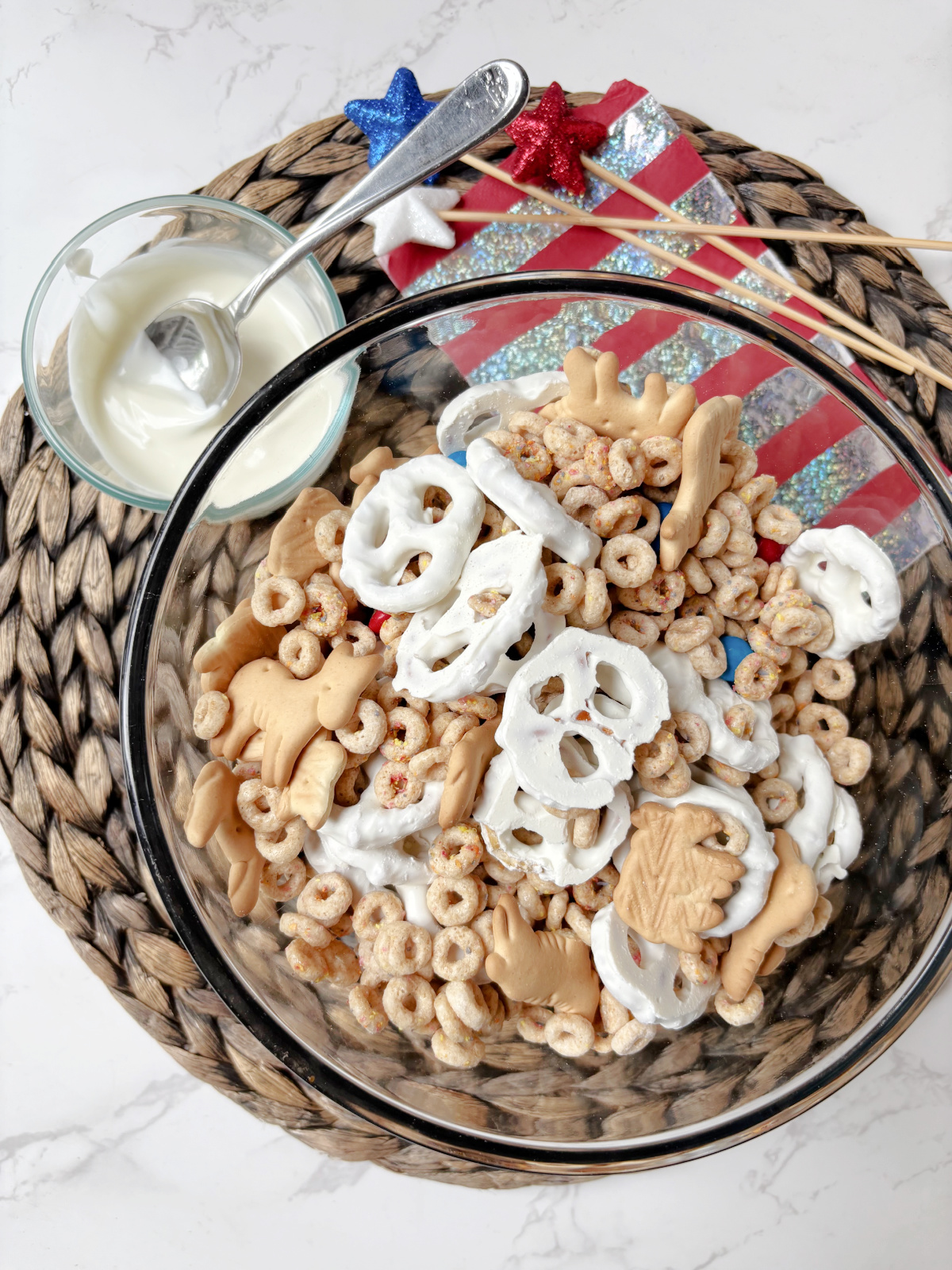 party mix in a clear bowl.
